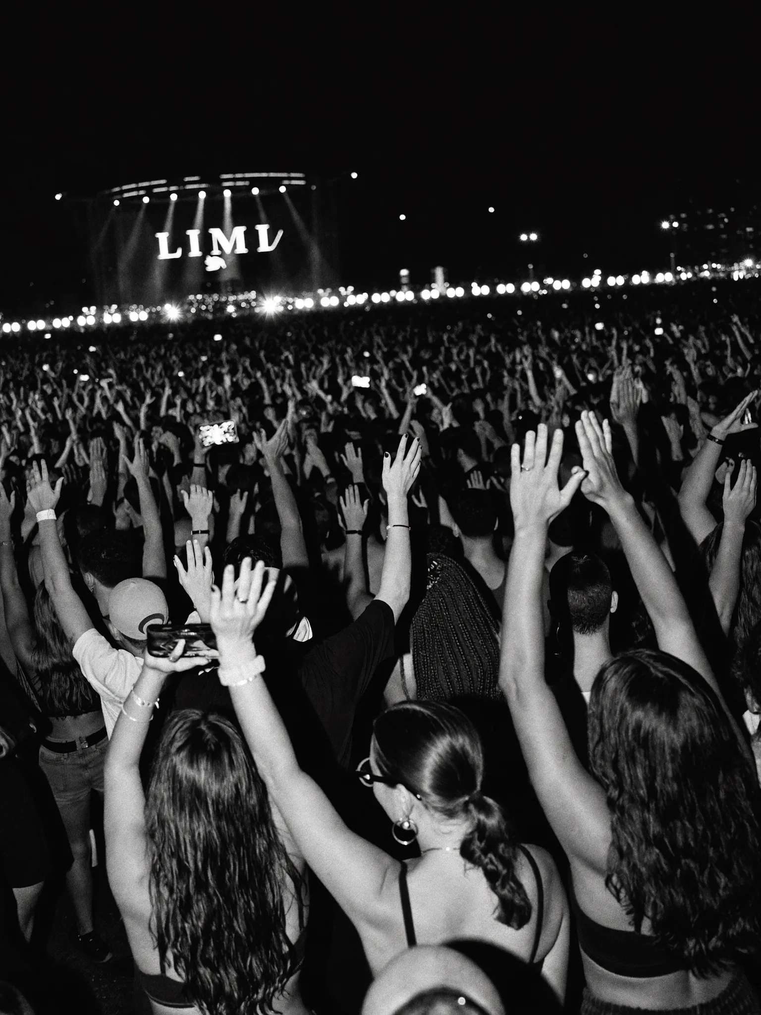 Electric Miami nightlife crowd with hands raised at an event